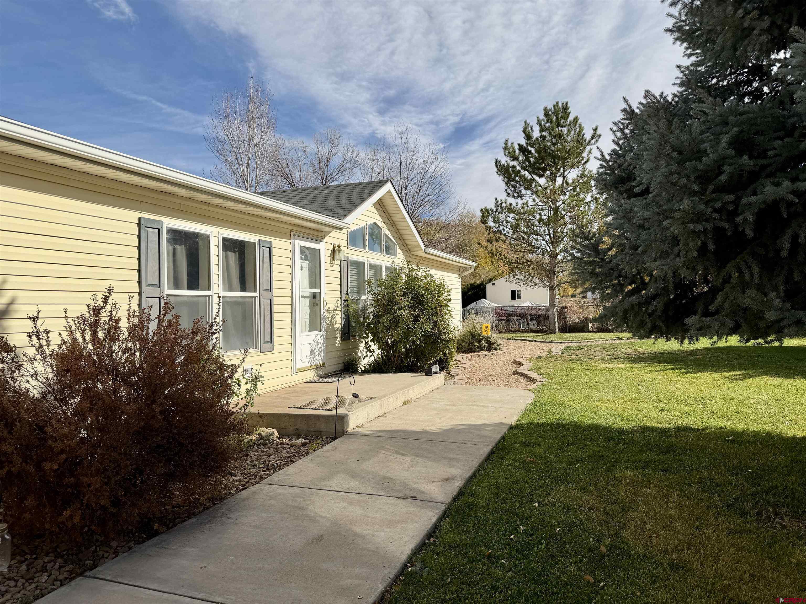 650 1725th Road Delta, CO 81416 - Photo 4 of 45 a front view of a house with garden