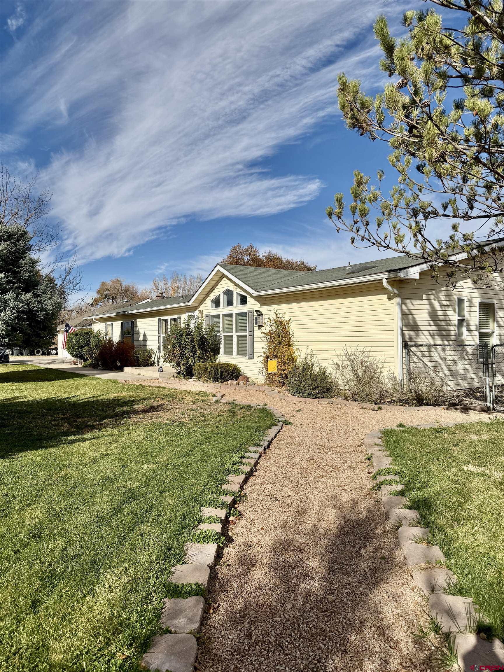 650 1725th Road Delta, CO 81416 - Photo 6 of 45 a front view of a house with garden