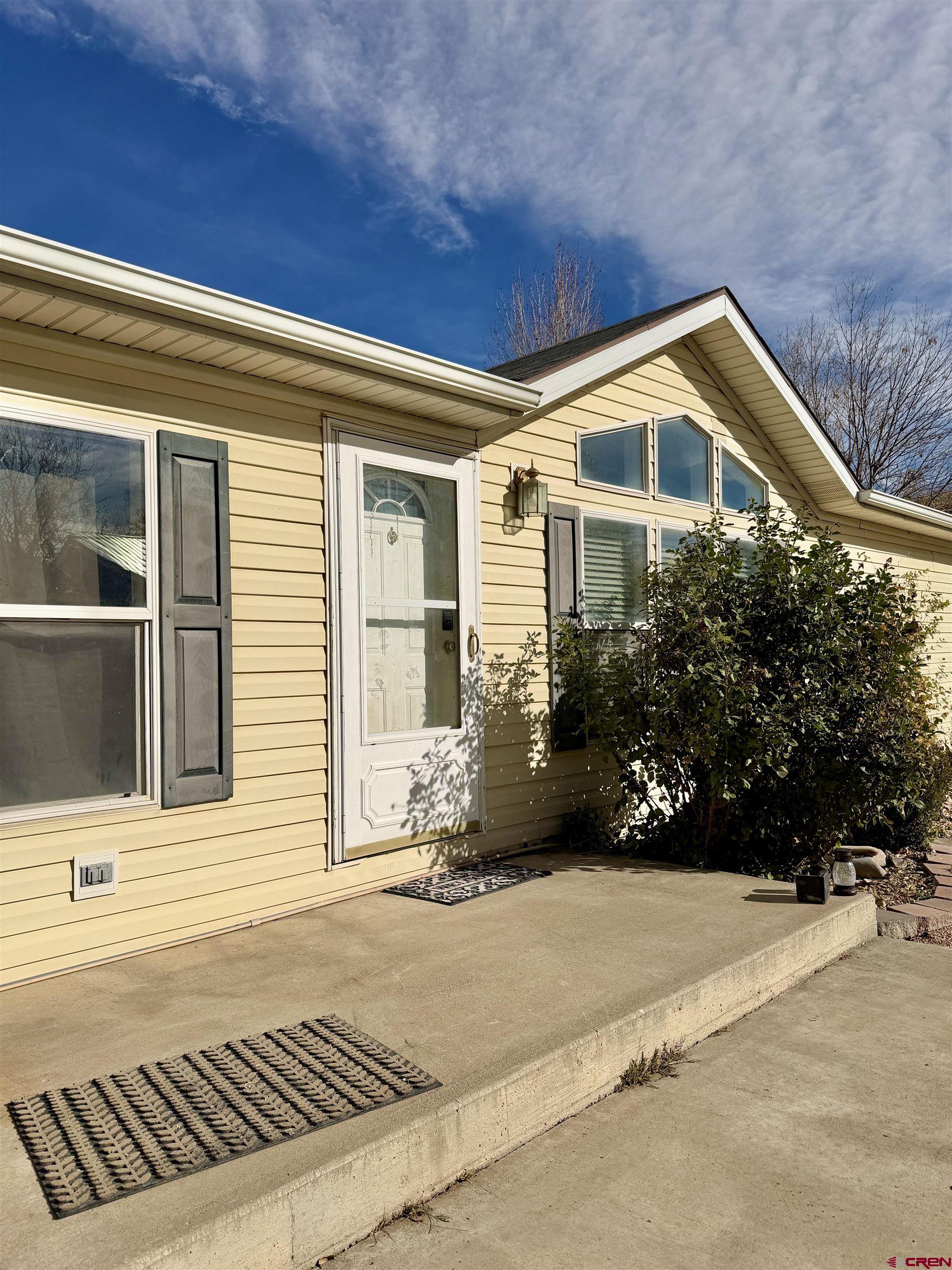 650 1725th Road Delta, CO 81416 - Photo 7 of 45 a front view of a house with a yard