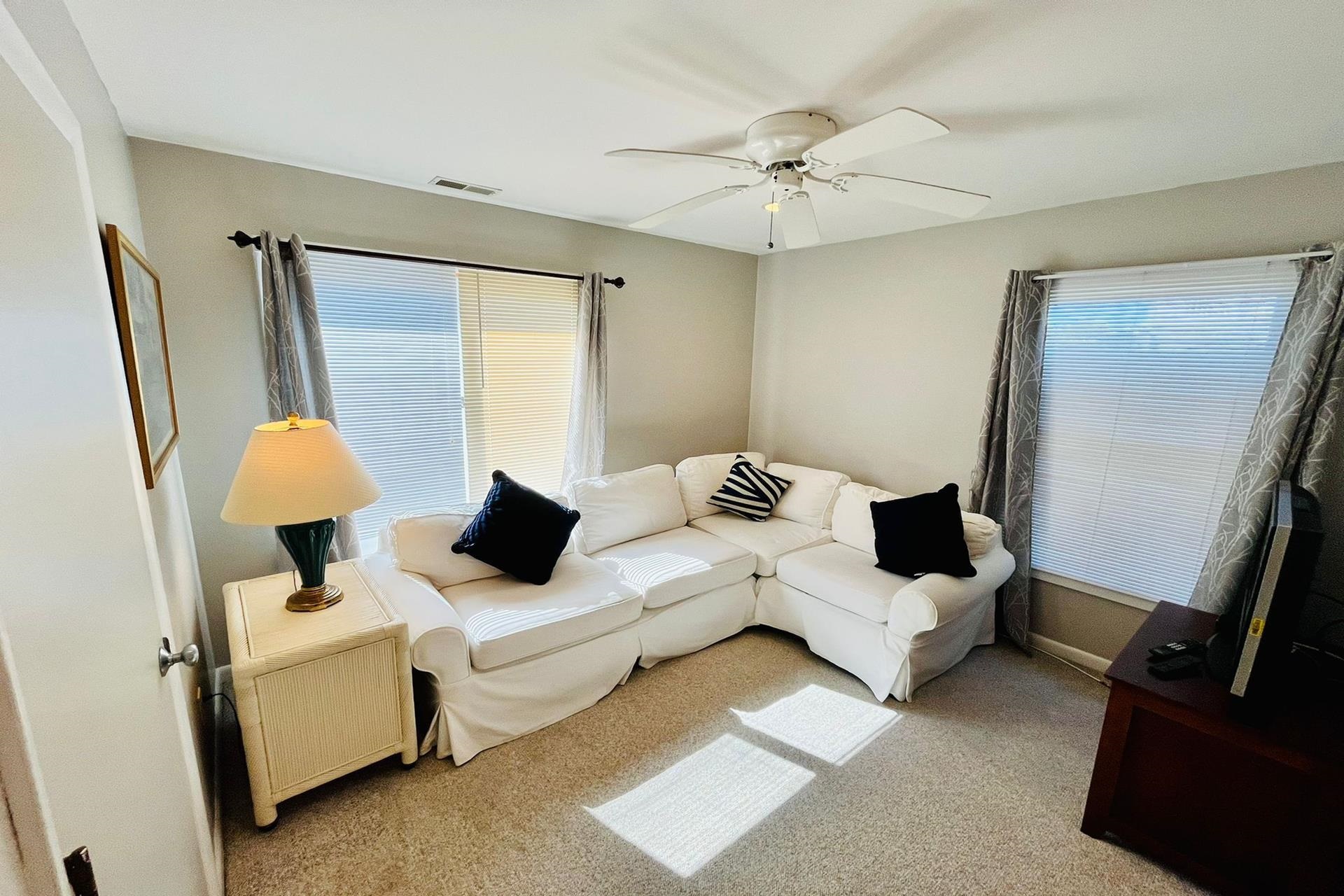 76 21st Street Avalon, NJ 08202 - Photo 13 of 18 a living room with furniture and a flat screen tv