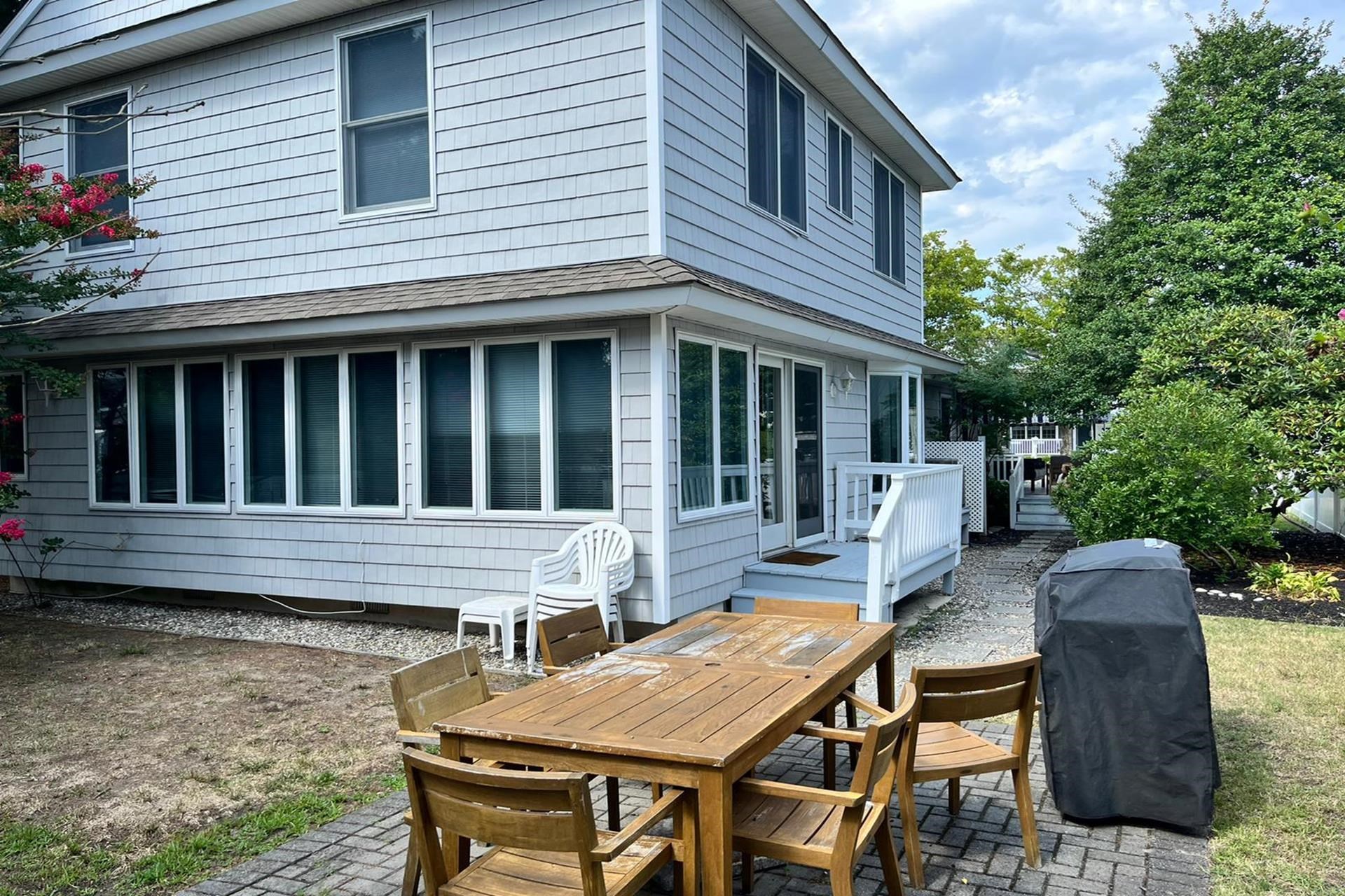 76 21st Street Avalon, NJ 08202 - Photo 18 of 18 a view of backyard with table and chairs and potted plants