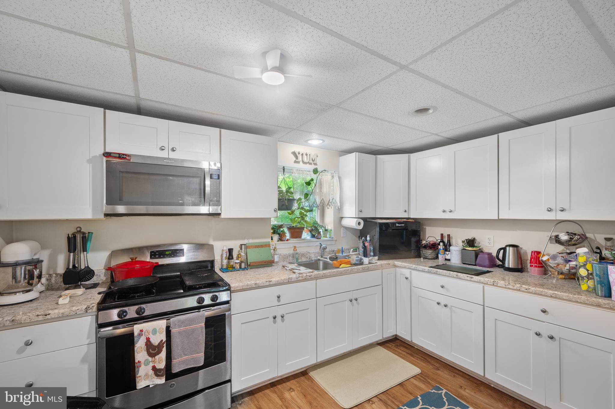 1908 Conowingo Road Rising Sun, MD 21911 - Photo 64 of 99 a kitchen with stainless steel appliances granite countertop a sink dishwasher stove and white cabinets with wooden floor