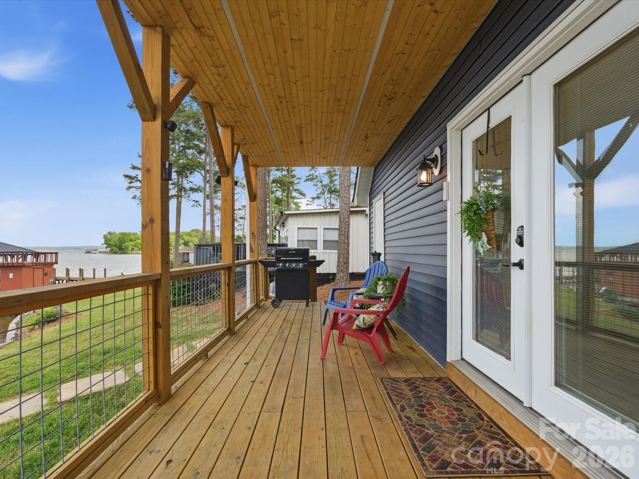 562 Lake Head Road Norwood, NC 28128 - Photo 28 of 43 a balcony with furniture and wooden floor