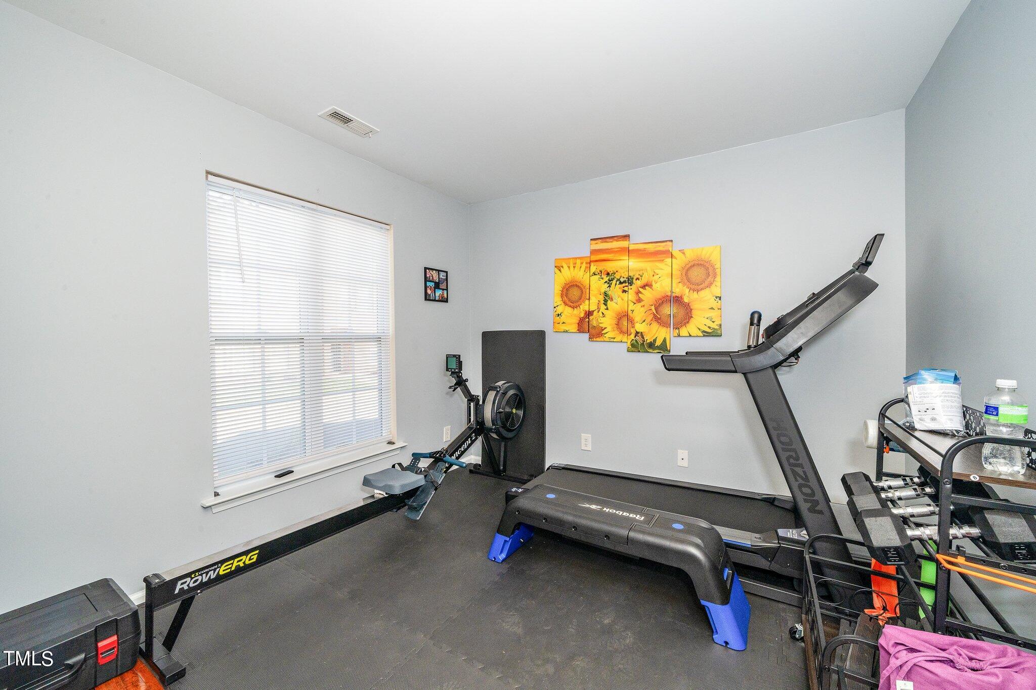 9813 Cicero Drive Raleigh, NC 27617 - Photo 12 of 21 a room with gym equipment and a large window