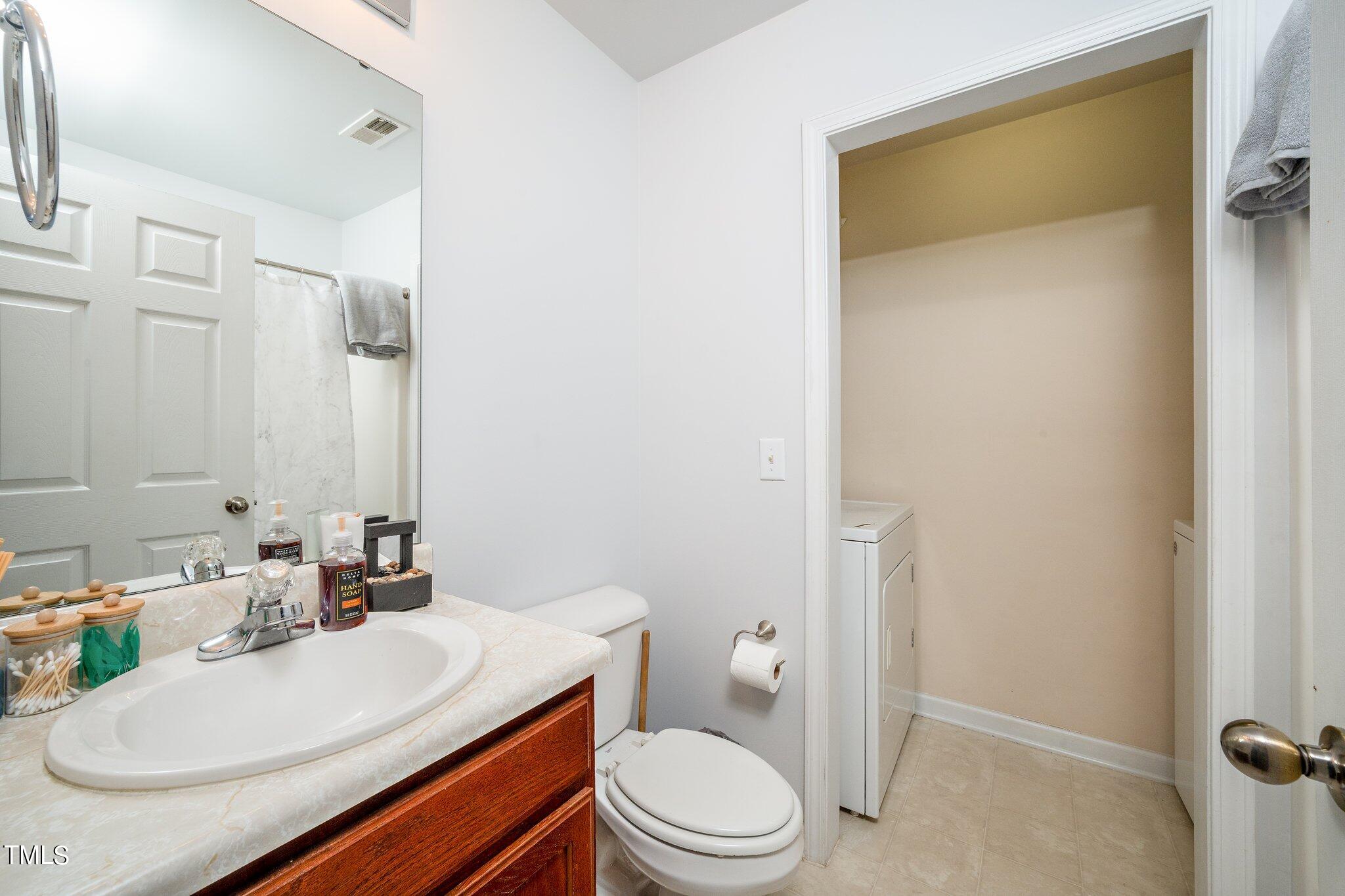 9813 Cicero Drive Raleigh, NC 27617 - Photo 13 of 21 a bathroom with a sink a toilet and shower
