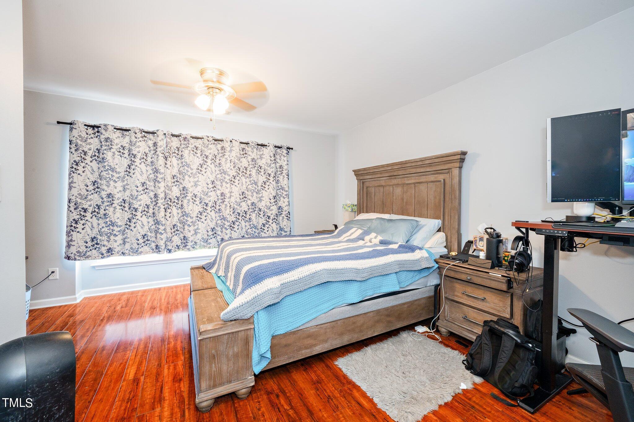 9813 Cicero Drive Raleigh, NC 27617 - Photo 14 of 21 a bedroom with a bed and a flat screen tv