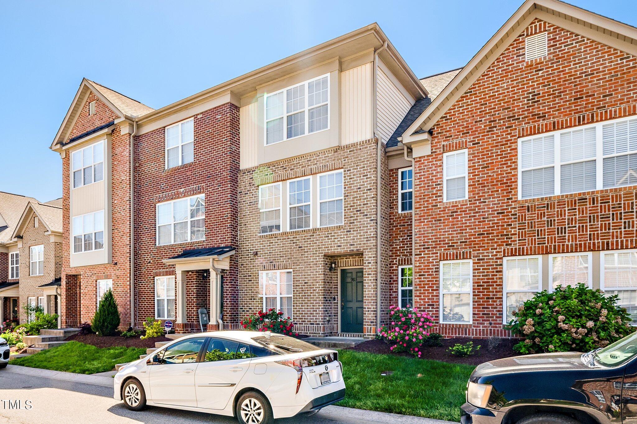 9813 Cicero Drive Raleigh, NC 27617 - Photo 21 of 21 a car parked in front of a brick house