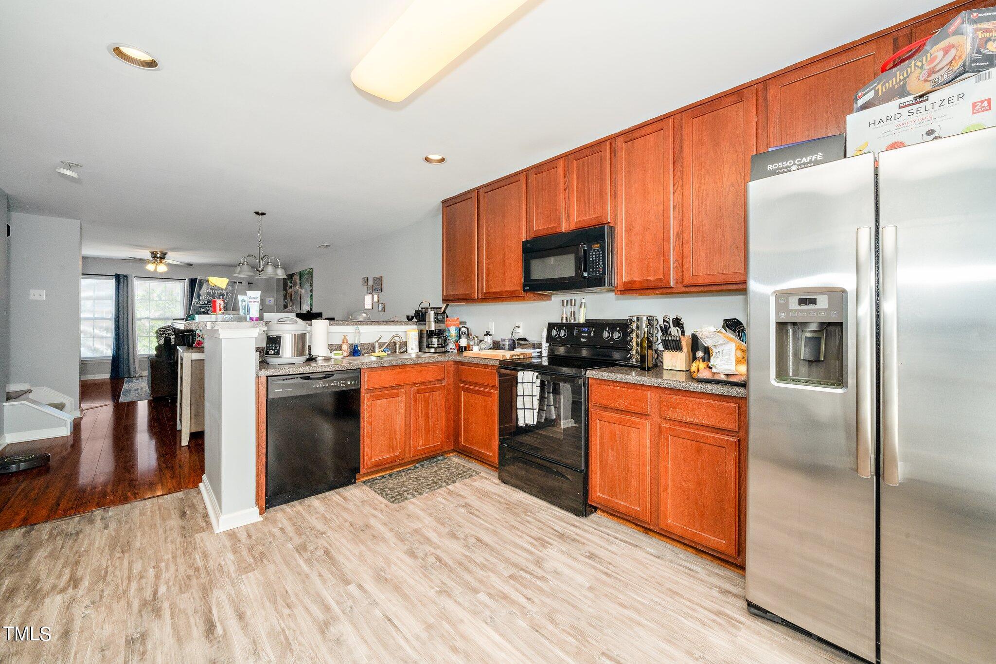 9813 Cicero Drive Raleigh, NC 27617 - Photo 6 of 21 a kitchen with stainless steel appliances granite countertop a refrigerator a stove top oven a sink and dishwasher