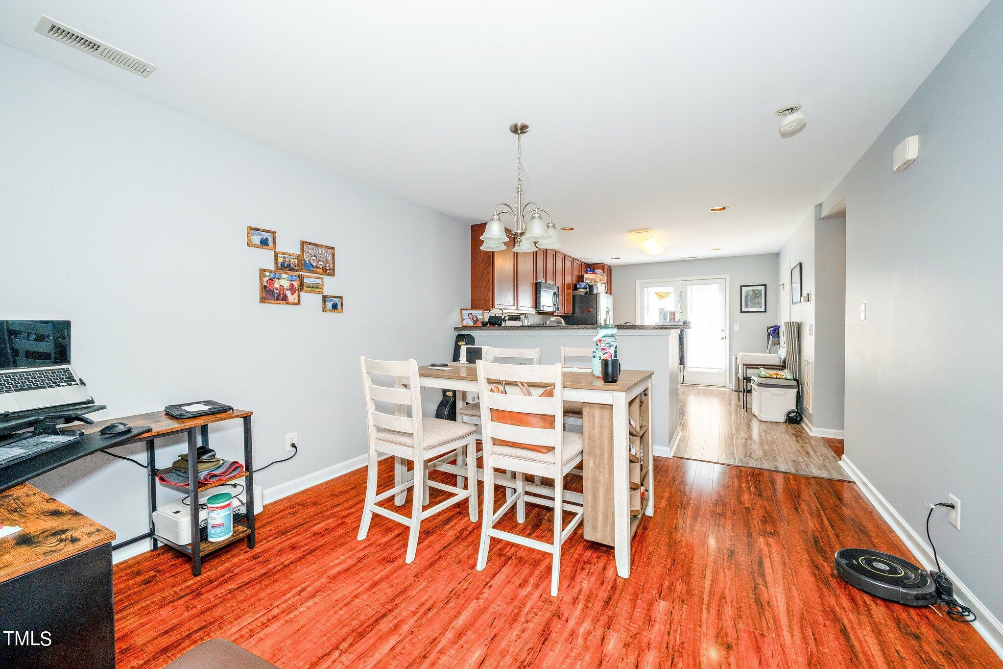 9813 Cicero Drive Raleigh, NC 27617 - Photo 8 of 21 a dining room with furniture and wooden floor