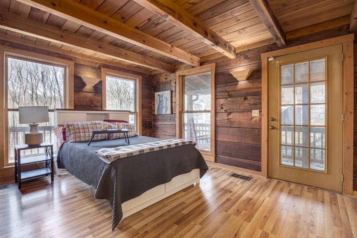 1762 Burke Hollow Road Nolensville, TN 37135 - Photo 16 of 52 a bedroom with a bed and a large window with wooden floor