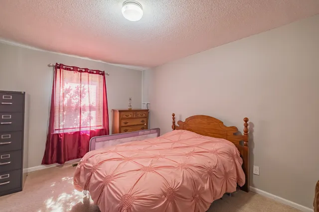 a bedroom with a bed and a television