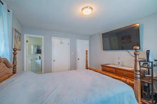 a bedroom with a bed and a flat screen tv