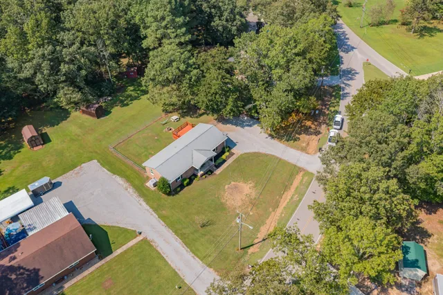 an aerial view of a house with a yard basket ball court and outdoor seating