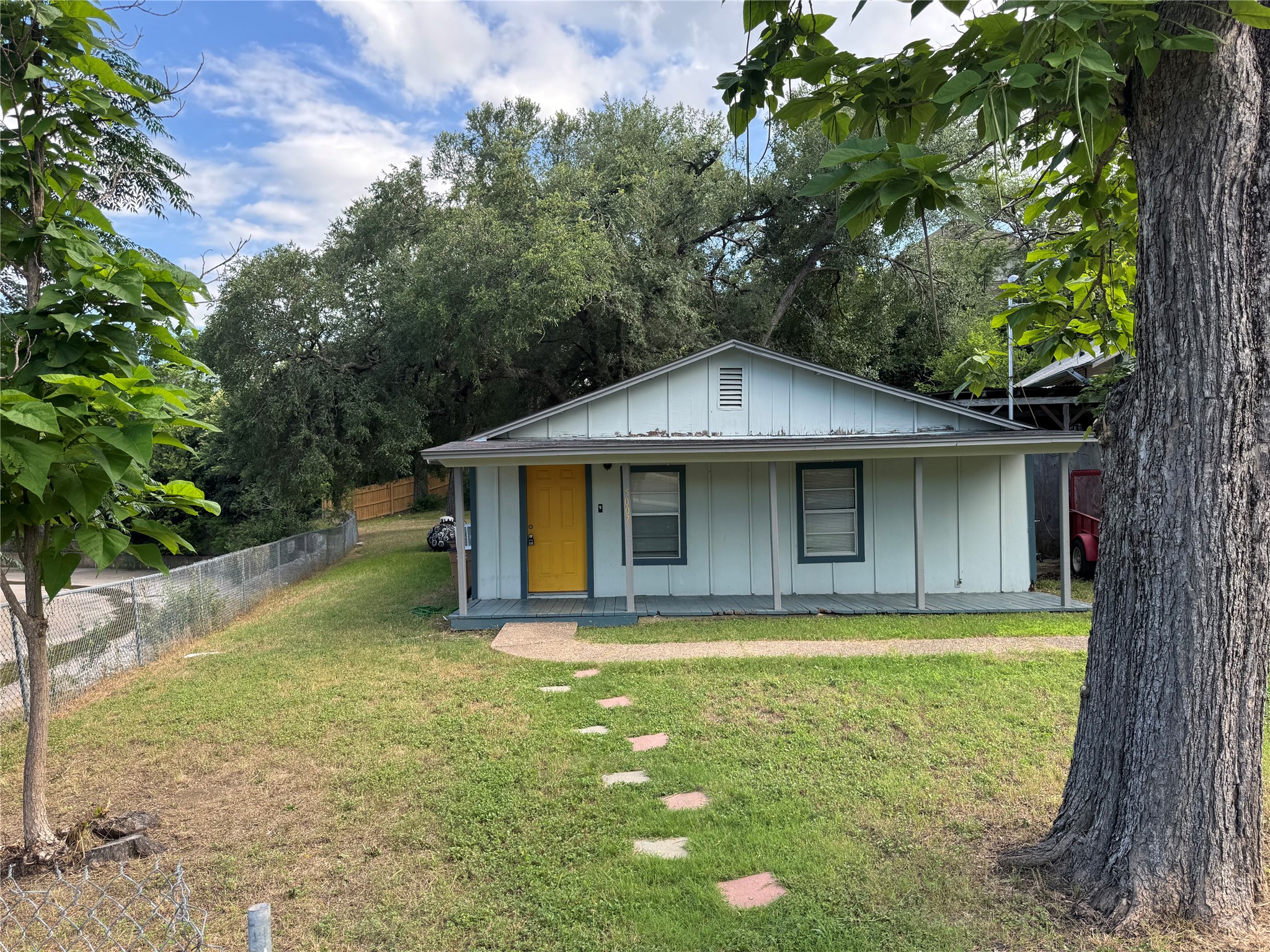 5007 Heflin Lane Austin, TX 78721 - Photo 25 of 25 A charming single-story residence with a vibrant entry and inviting front porch.