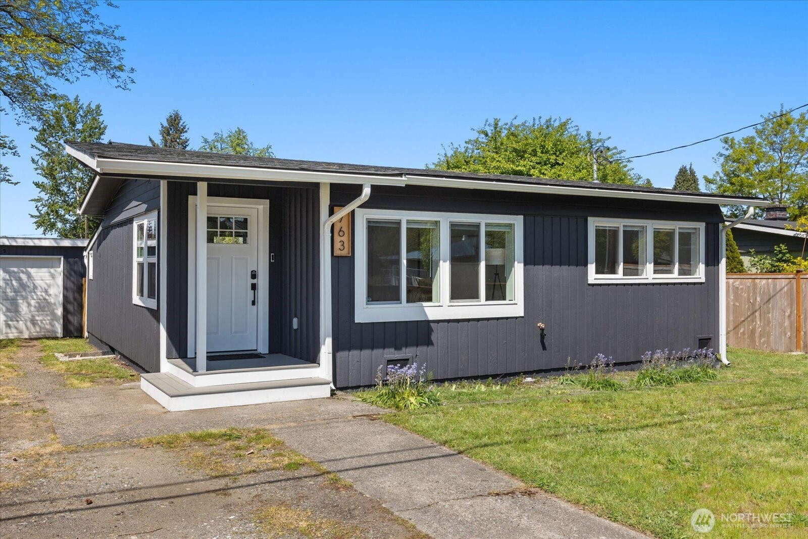 763 Edmonds Avenue Northeast Renton, WA 98056 - Photo 1 of 26 a front view of a house with a yard