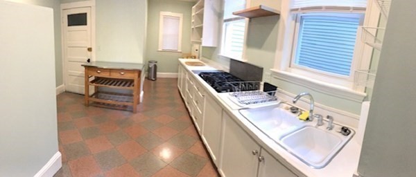 26 Tower Street Boston, MA 02130 - Photo 5 of 17 a kitchen with sink stove and cabinets