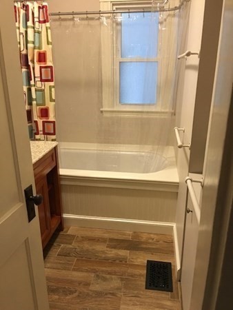 26 Tower Street Boston, MA 02130 - Photo 6 of 17 a bathroom with a shower and a bath tub