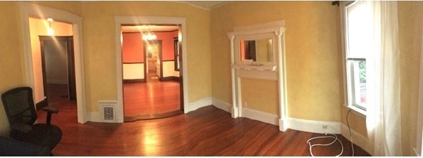 26 Tower Street Boston, MA 02130 - Photo 7 of 17 a view of a hallway with wooden floor and glass door