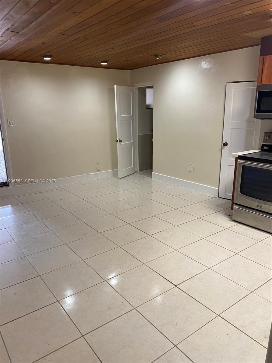 1051 Southwest 3rd Street, Unit 3 Miami, FL 33130 - Photo 3 of 8 a view of a refrigerator in the room