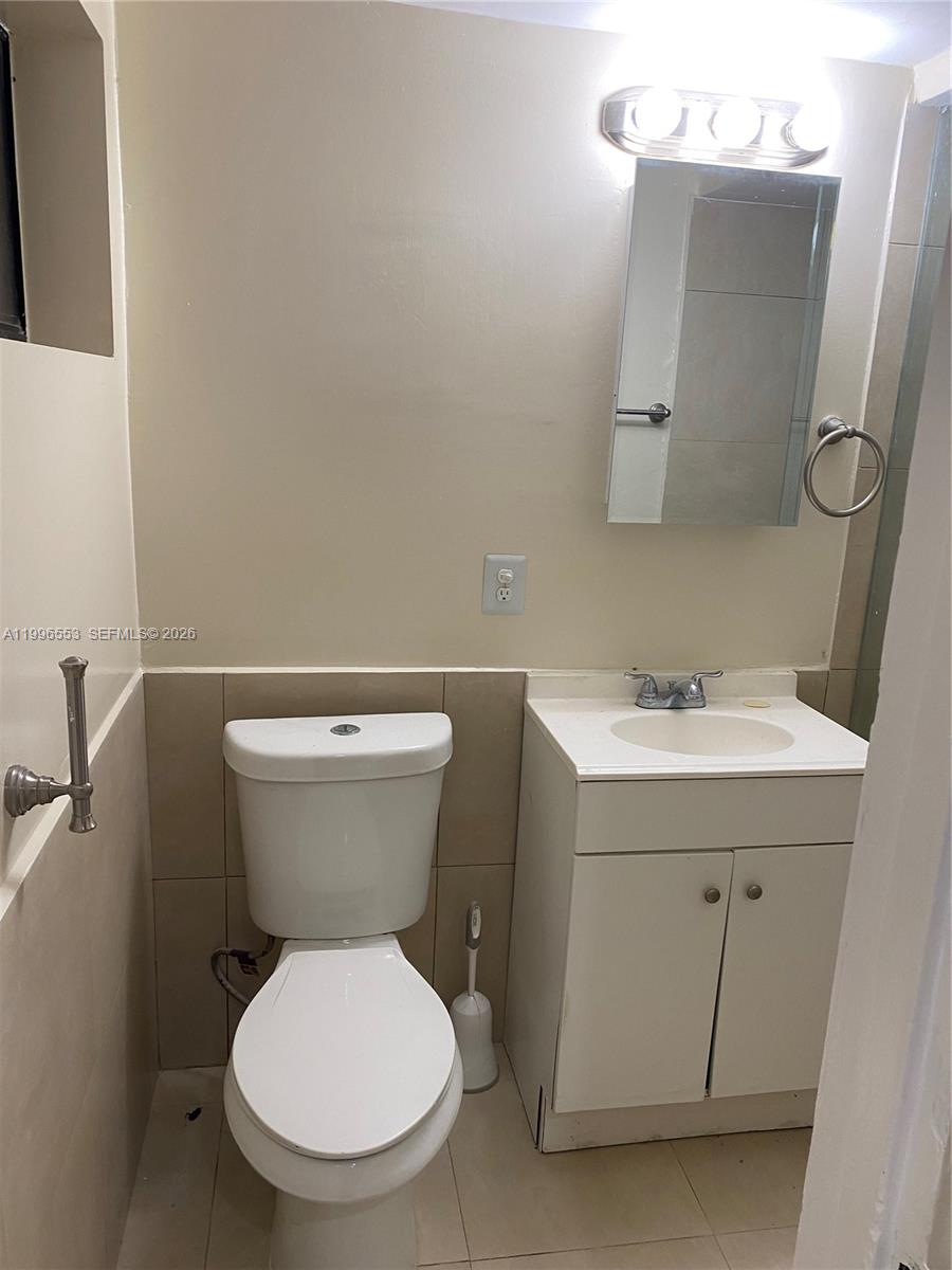 1051 Southwest 3rd Street, Unit 3 Miami, FL 33130 - Photo 8 of 8 a white toilet sitting next to a bathroom sink