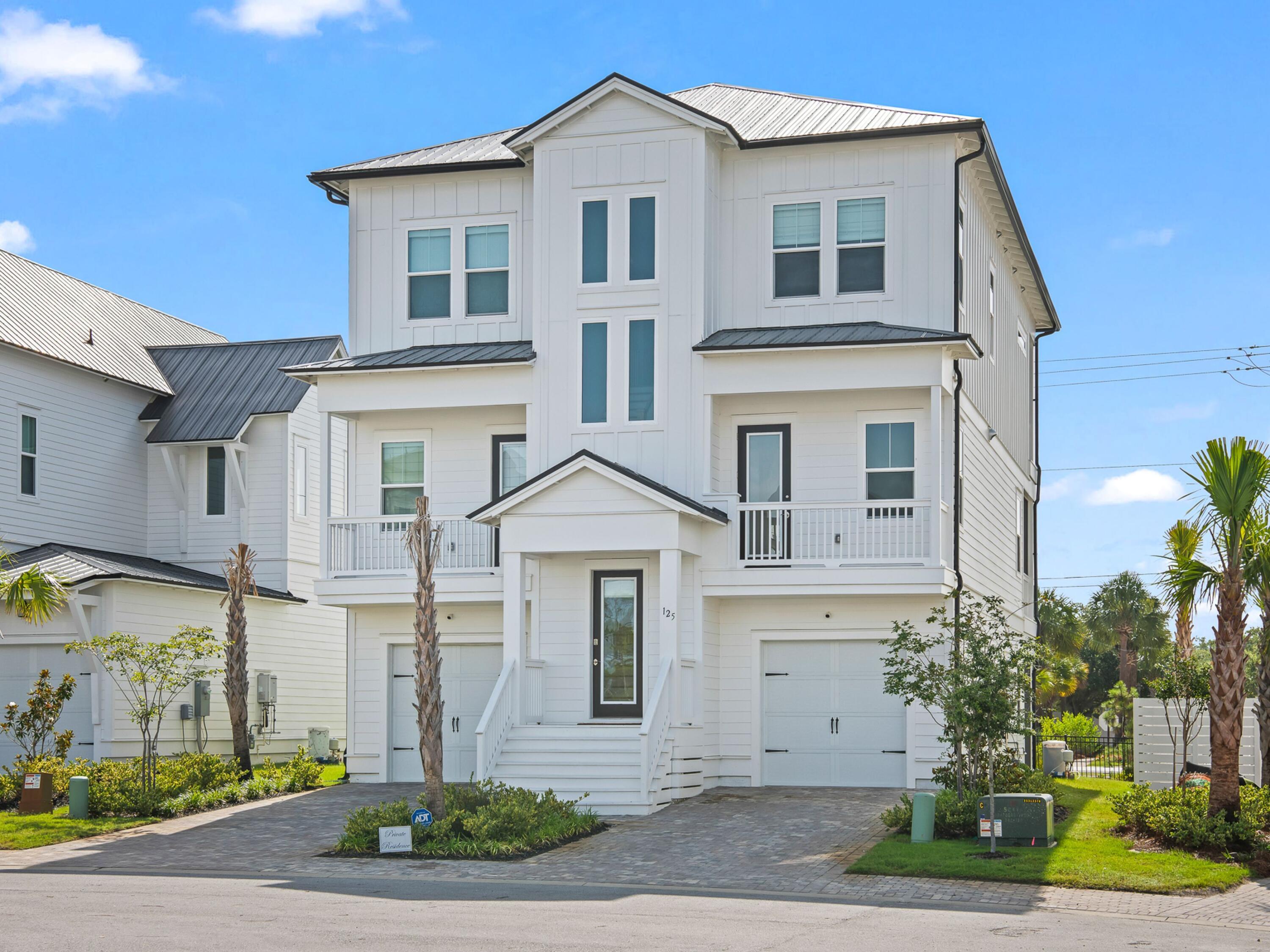 125 Seaboard Lane Santa Rosa Beach, FL 32459 - Photo 1 of 49 a front view of a house with garden
