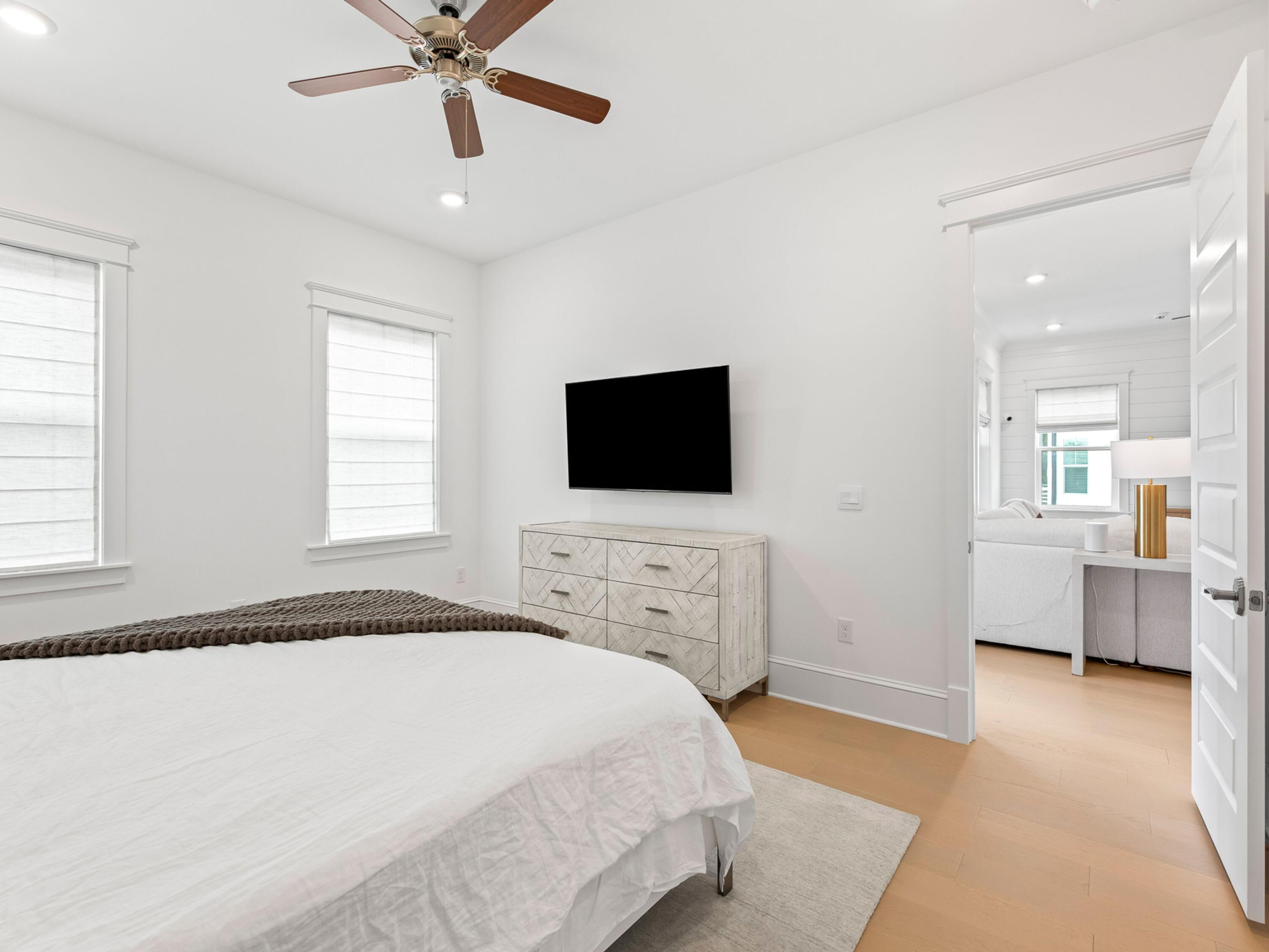 125 Seaboard Lane Santa Rosa Beach, FL 32459 - Photo 15 of 49 a spacious bedroom with a bed and a flat screen tv
