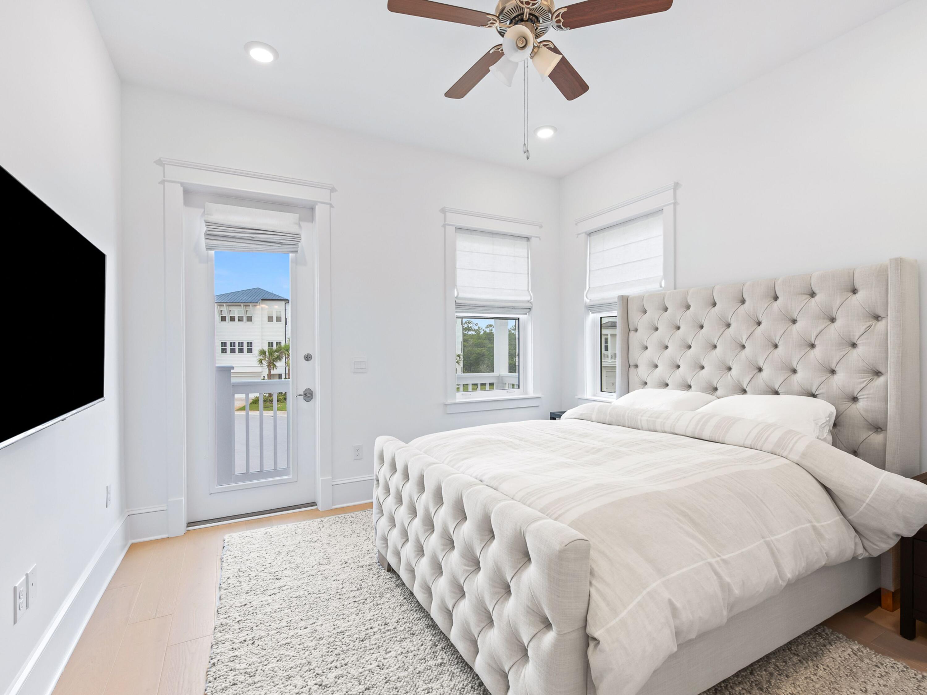 125 Seaboard Lane Santa Rosa Beach, FL 32459 - Photo 18 of 49 a bedroom with a large bed and a flat tv screen on dresser