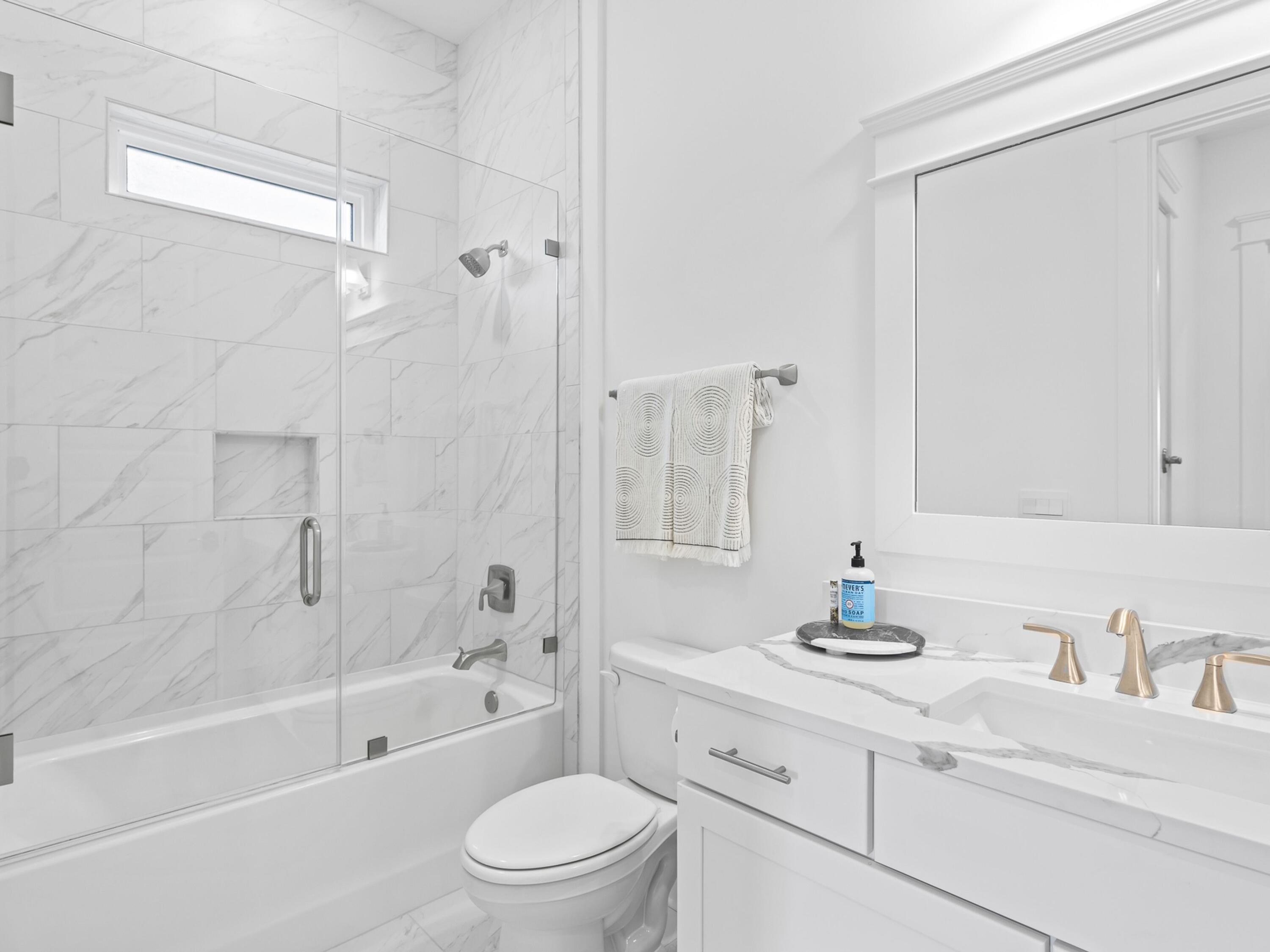 125 Seaboard Lane Santa Rosa Beach, FL 32459 - Photo 20 of 49 a bathroom with a bathtub shower sink vanity mirror and toilet