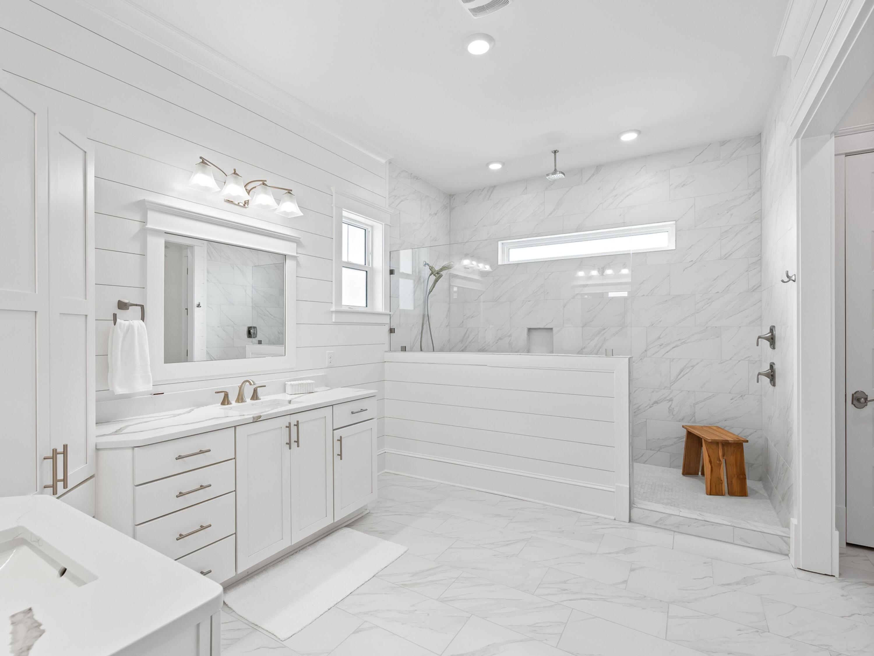 125 Seaboard Lane Santa Rosa Beach, FL 32459 - Photo 25 of 49 a bathroom with a double vanity sink a mirror a bathtub and shower