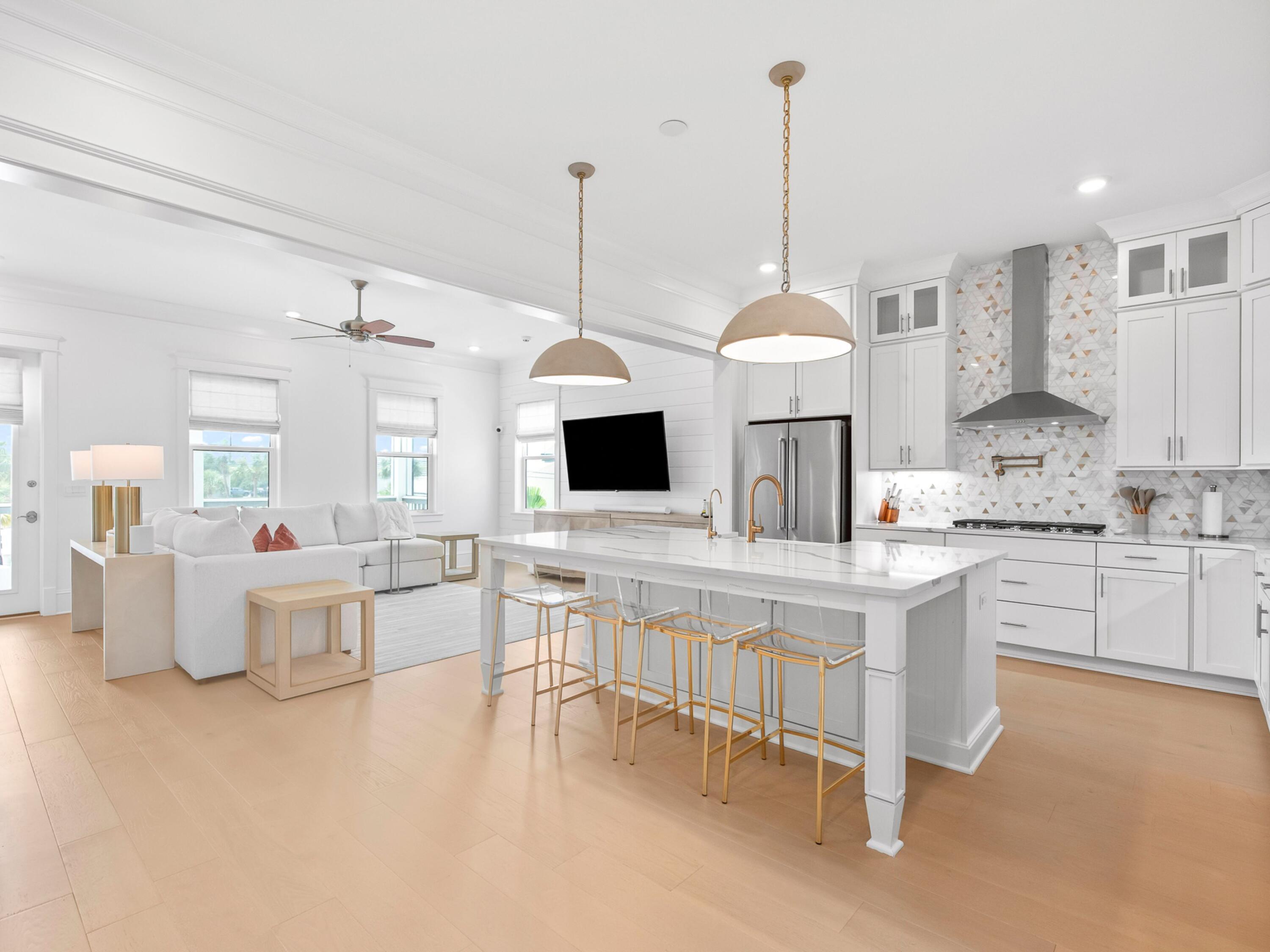 125 Seaboard Lane Santa Rosa Beach, FL 32459 - Photo 3 of 49 a kitchen with white cabinets and white appliances