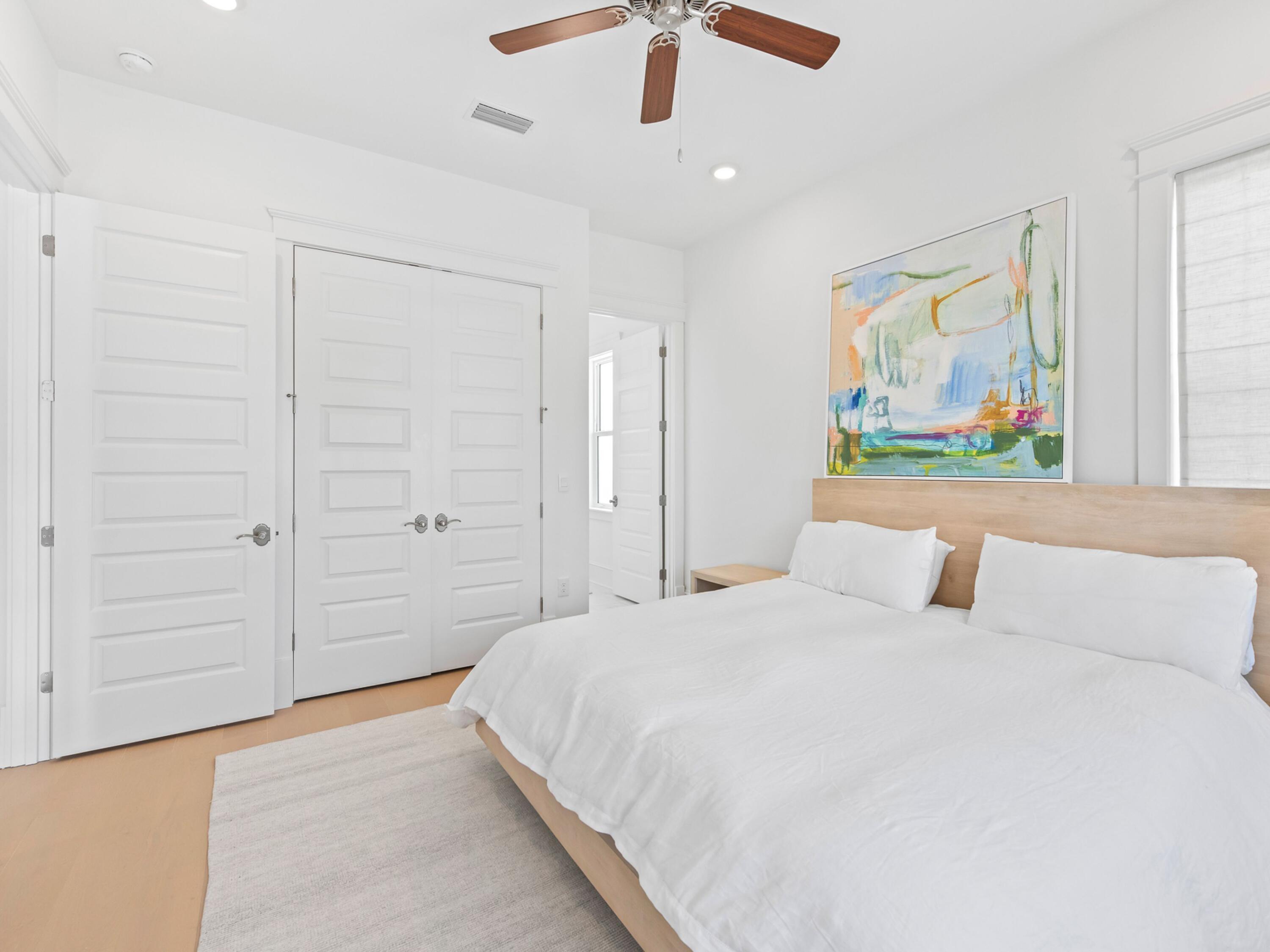 125 Seaboard Lane Santa Rosa Beach, FL 32459 - Photo 31 of 49 a bedroom with a large bed and a painting on the wall