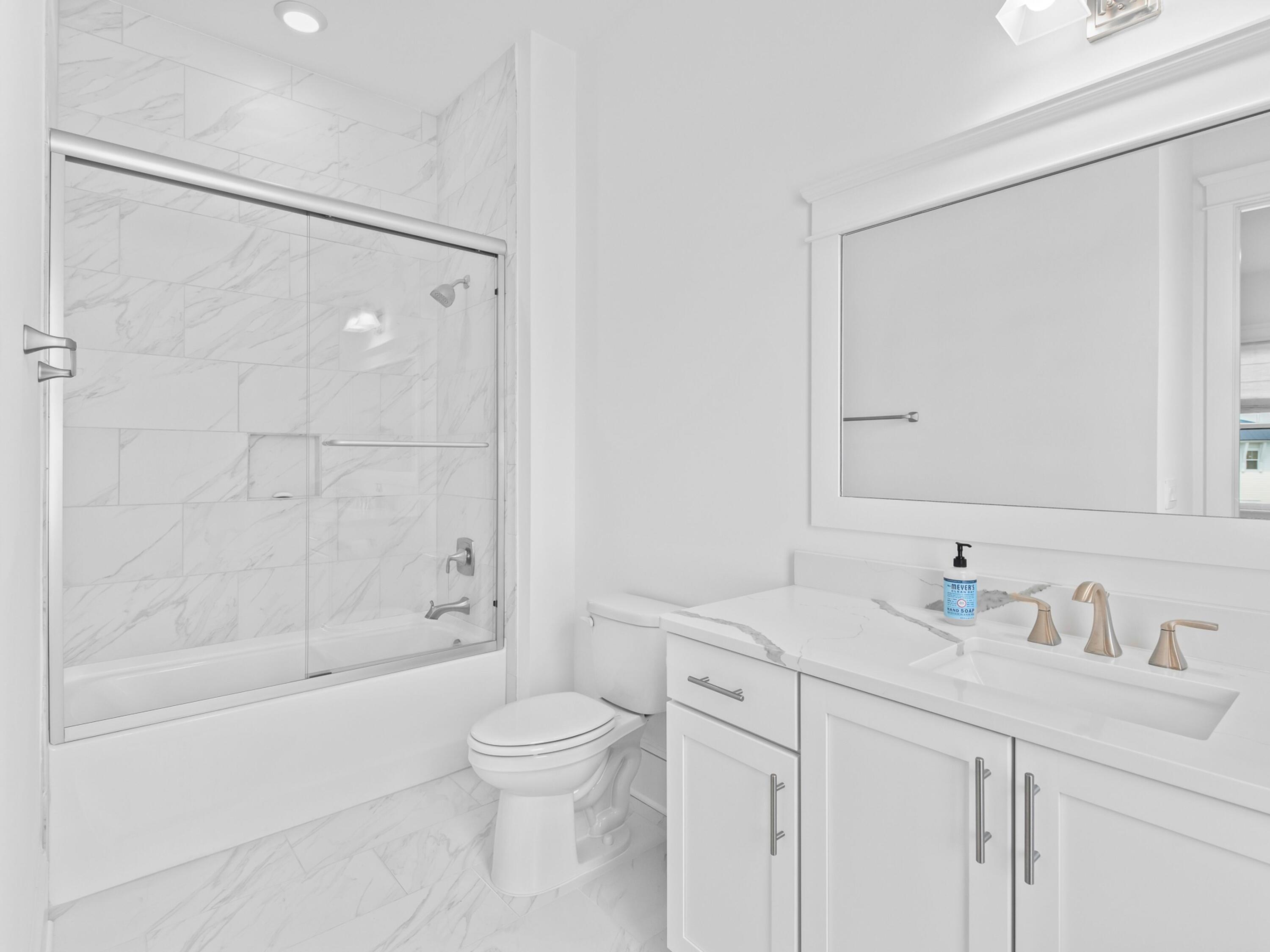 125 Seaboard Lane Santa Rosa Beach, FL 32459 - Photo 32 of 49 a bathroom with a sink a toilet and shower