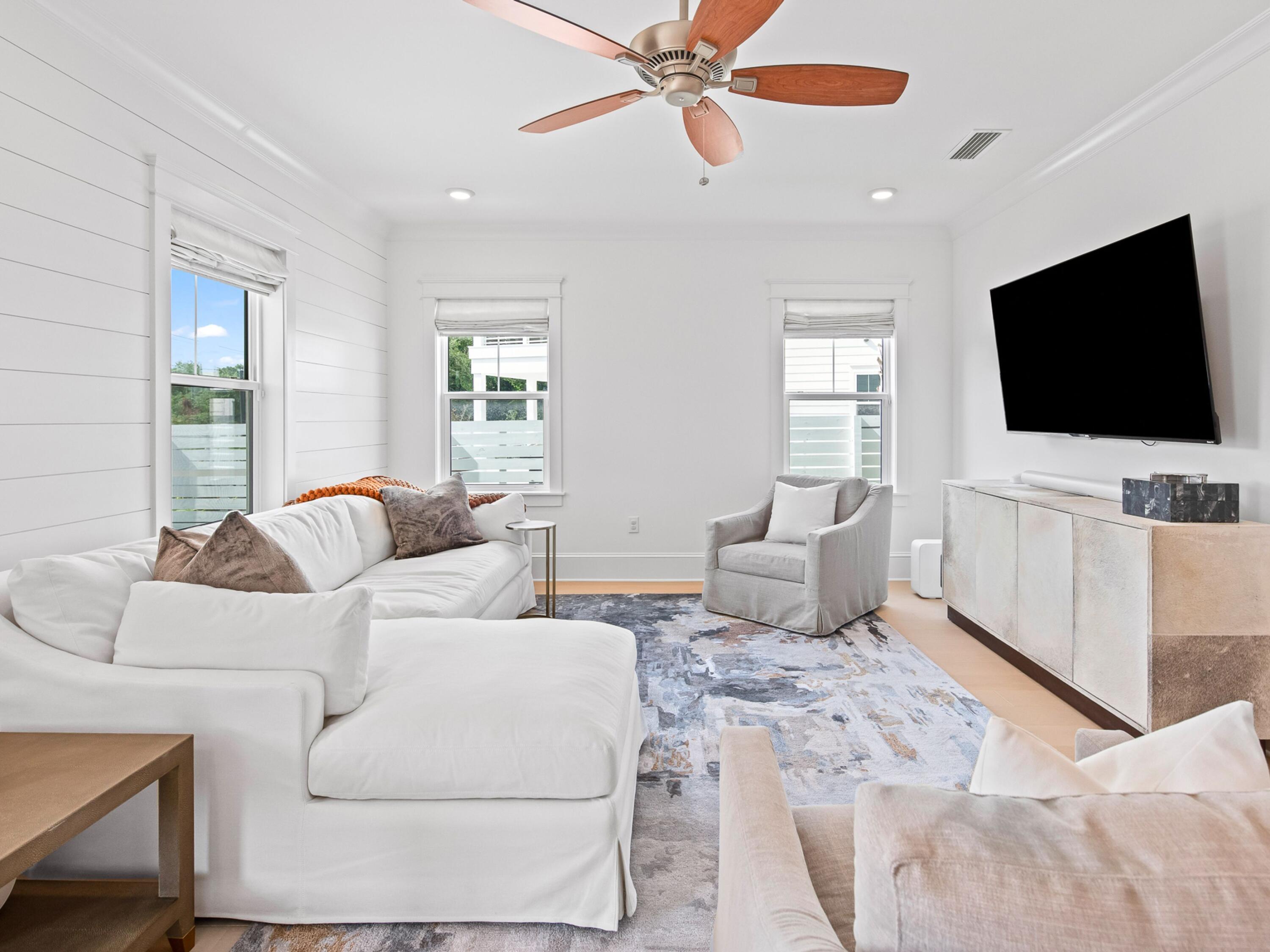 125 Seaboard Lane Santa Rosa Beach, FL 32459 - Photo 40 of 49 a living room with furniture and a flat screen tv