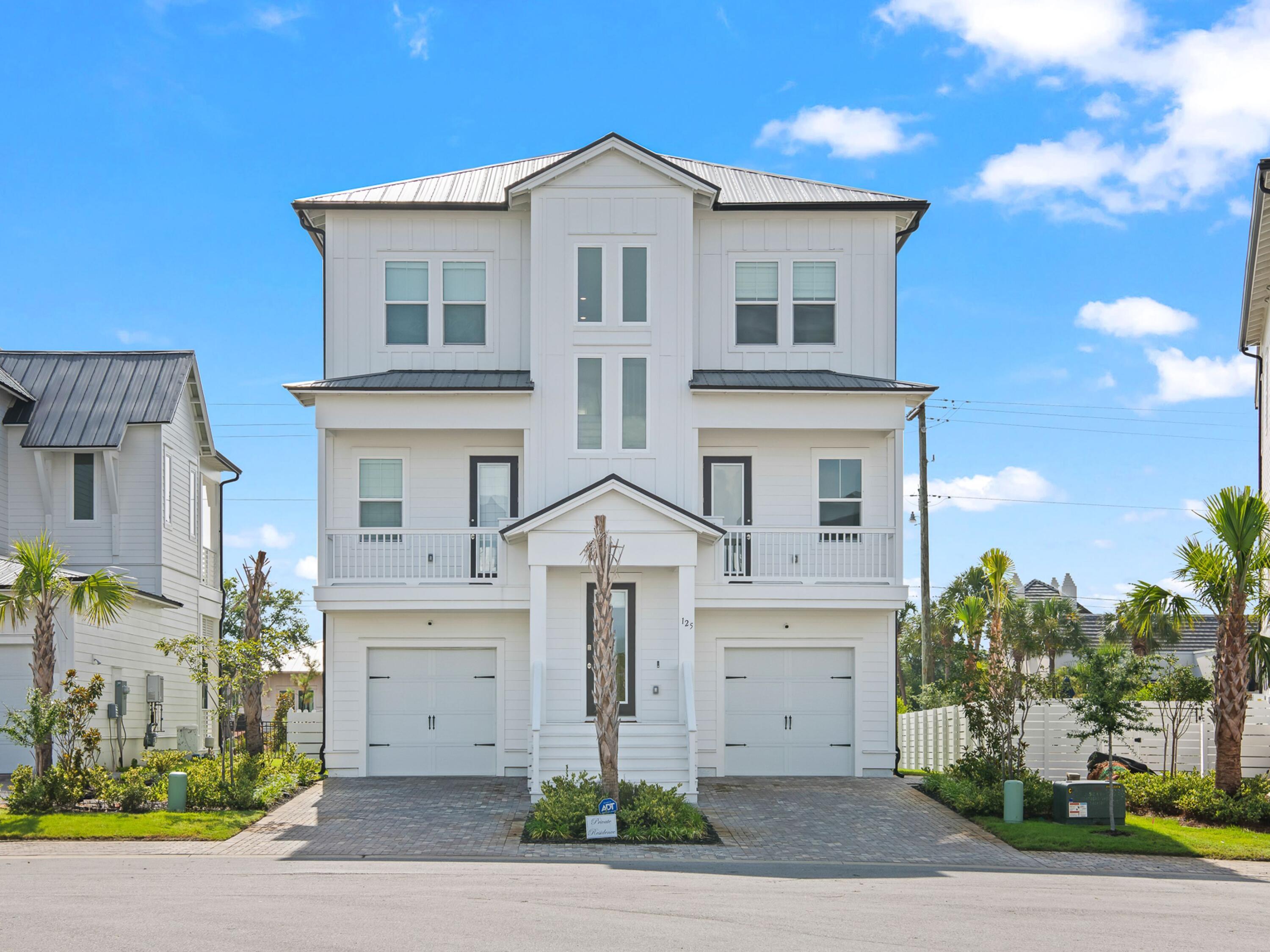 125 Seaboard Lane Santa Rosa Beach, FL 32459 - Photo 47 of 49 a front view of a house with a yard and garage