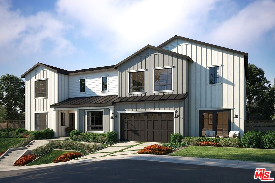 13423 Bayliss Road Los Angeles, CA 90049 - Photo 2 of 9 a front view of a house with a yard and garage