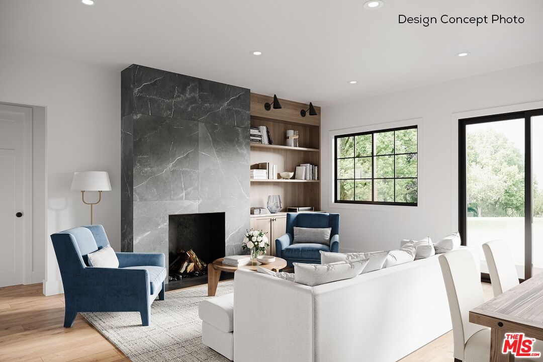 13423 Bayliss Road Los Angeles, CA 90049 - Photo 4 of 9 a living room with furniture a fireplace and a large window