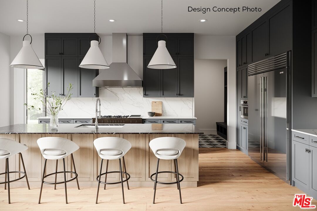 13423 Bayliss Road Los Angeles, CA 90049 - Photo 6 of 9 a kitchen with stainless steel appliances granite countertop a sink a stove a refrigerator and a microwave