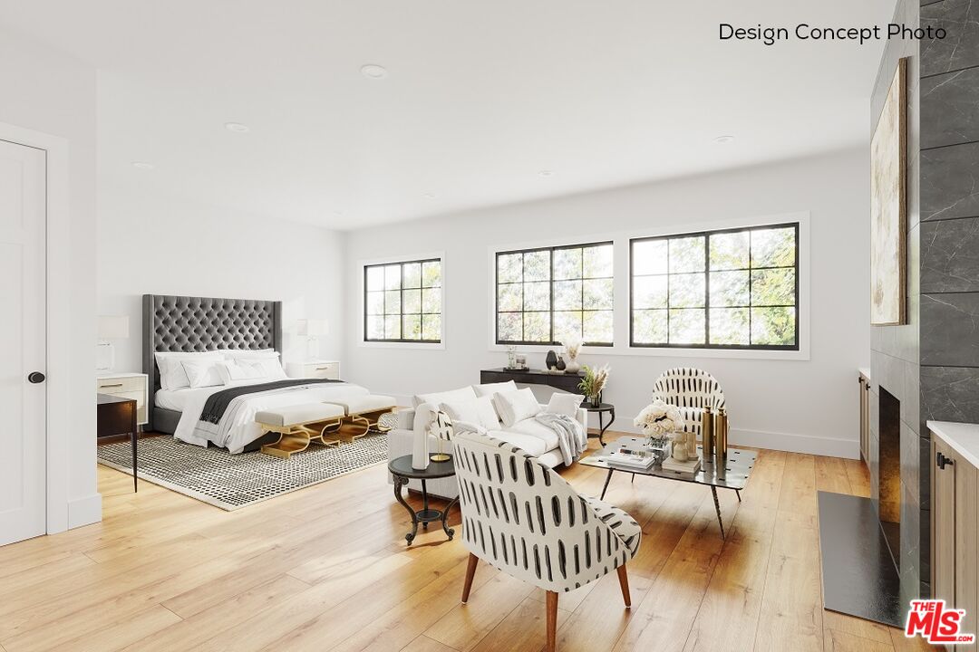 13423 Bayliss Road Los Angeles, CA 90049 - Photo 8 of 9 a spacious bedroom with a bed a couch and a dresser next to a window