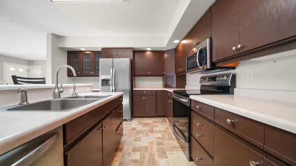 a kitchen with stainless steel appliances granite countertop a sink and stove