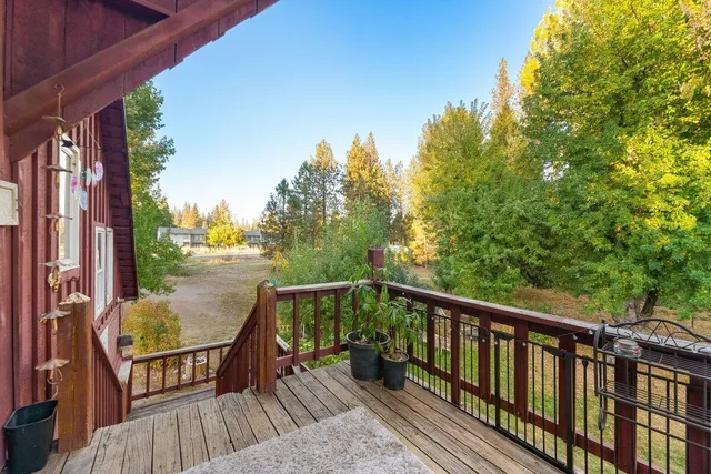 a view of balcony with wooden floor and fence