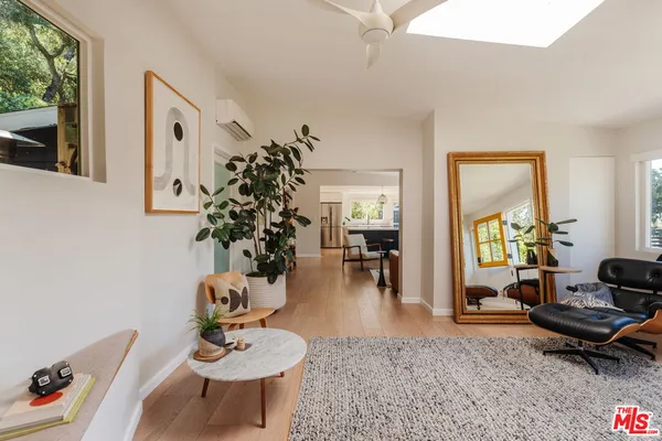 a view of a livingroom with furniture and hardwood floor