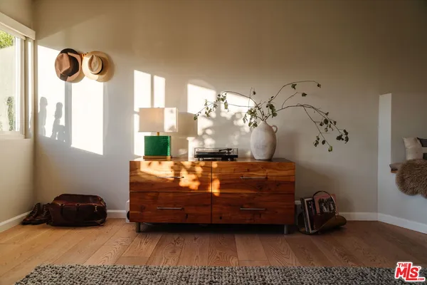 a living room with furniture flowers and a potted plant