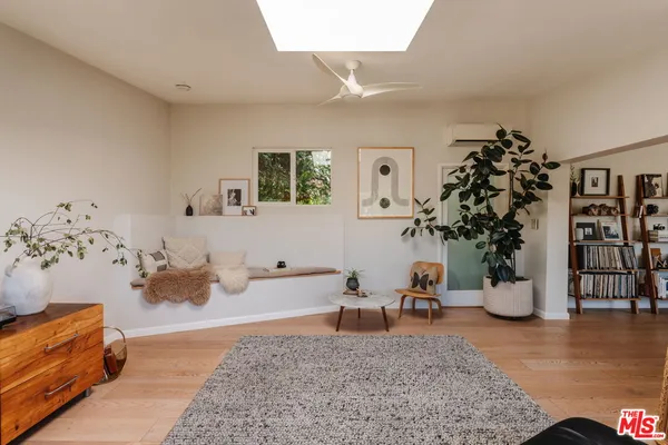 a large bed sitting in a bedroom next to a window