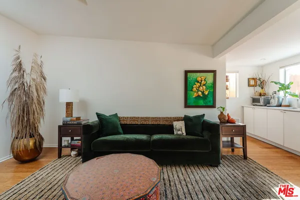 a living room with furniture and a floor to ceiling window