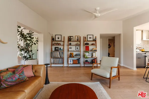 a living room with furniture and painting on the wall