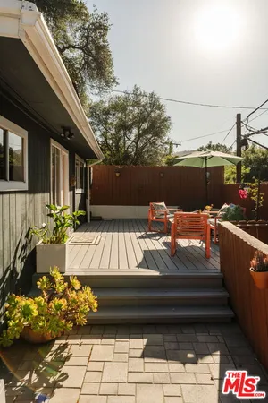 a living room with furniture and a book shelf