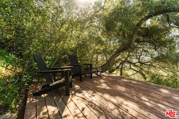 an outdoor sitting area with furniture and umbrella