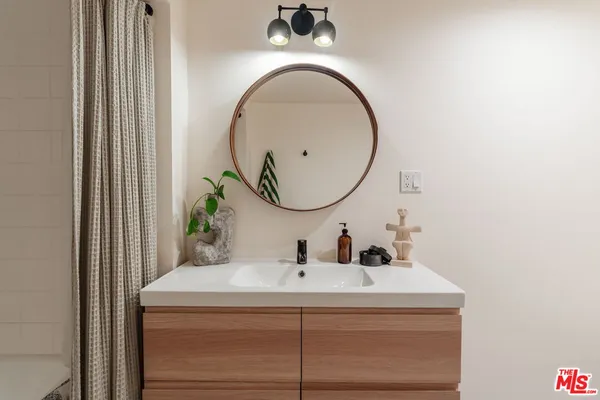 a living room with furniture and a lamp