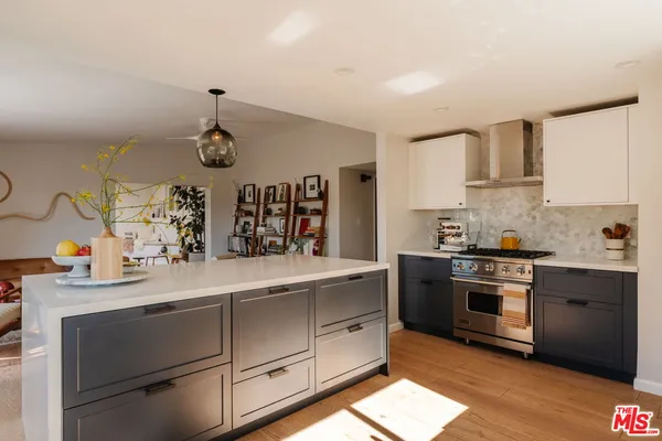 a kitchen with a sink and a wooden floor