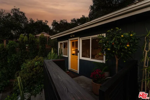 a view of house with backyard outdoor seating and green space